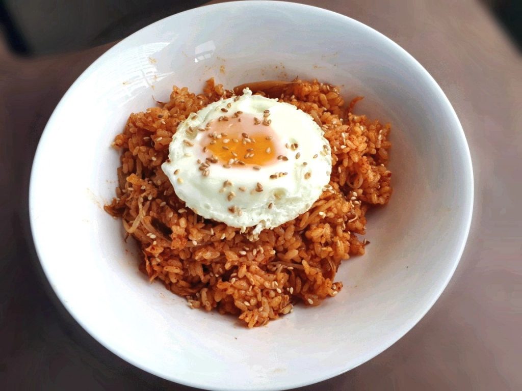 A korean rice dish called Kimchi Fried Rice served with sunny side up egg