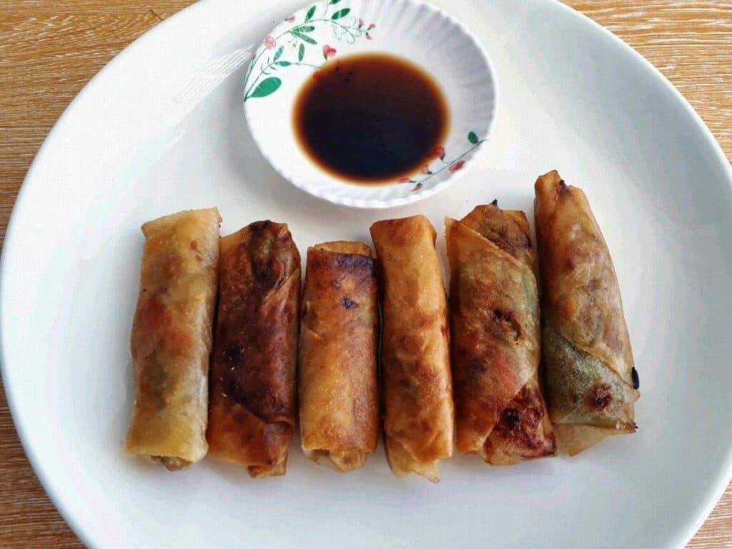 Vegetable Lumpia served with Vinegar Soy Sauce in a plate