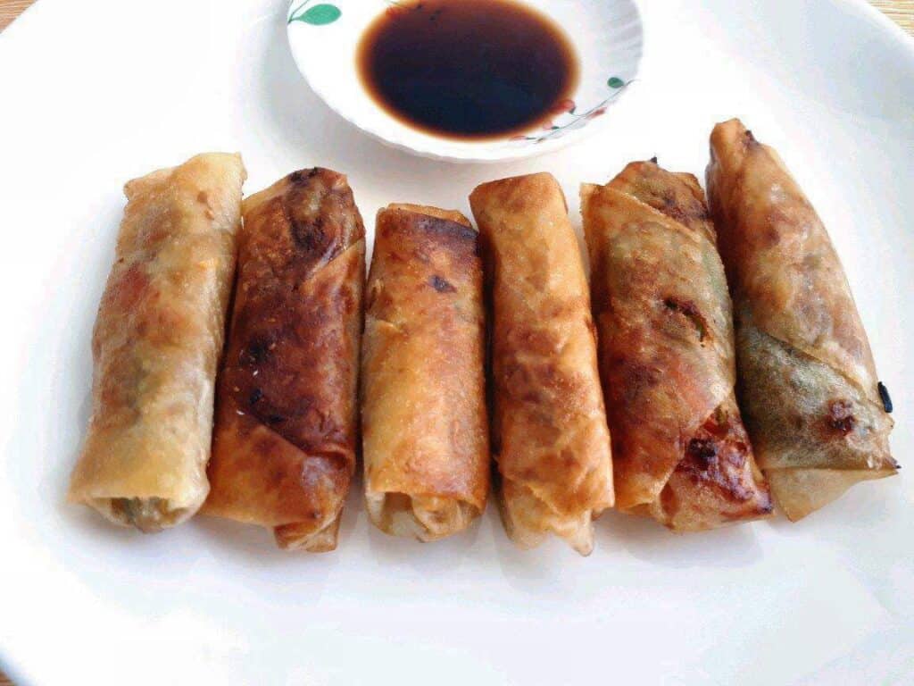 Vegetable Lumpia served with Vinegar Soy Sauce in a plate