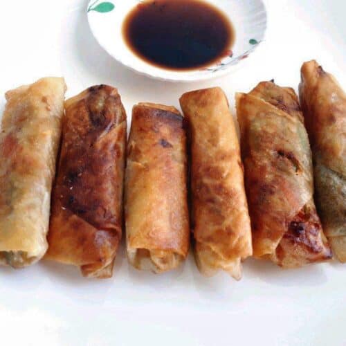 Vegetable Lumpia served with Vinegar Soy Sauce in a plate