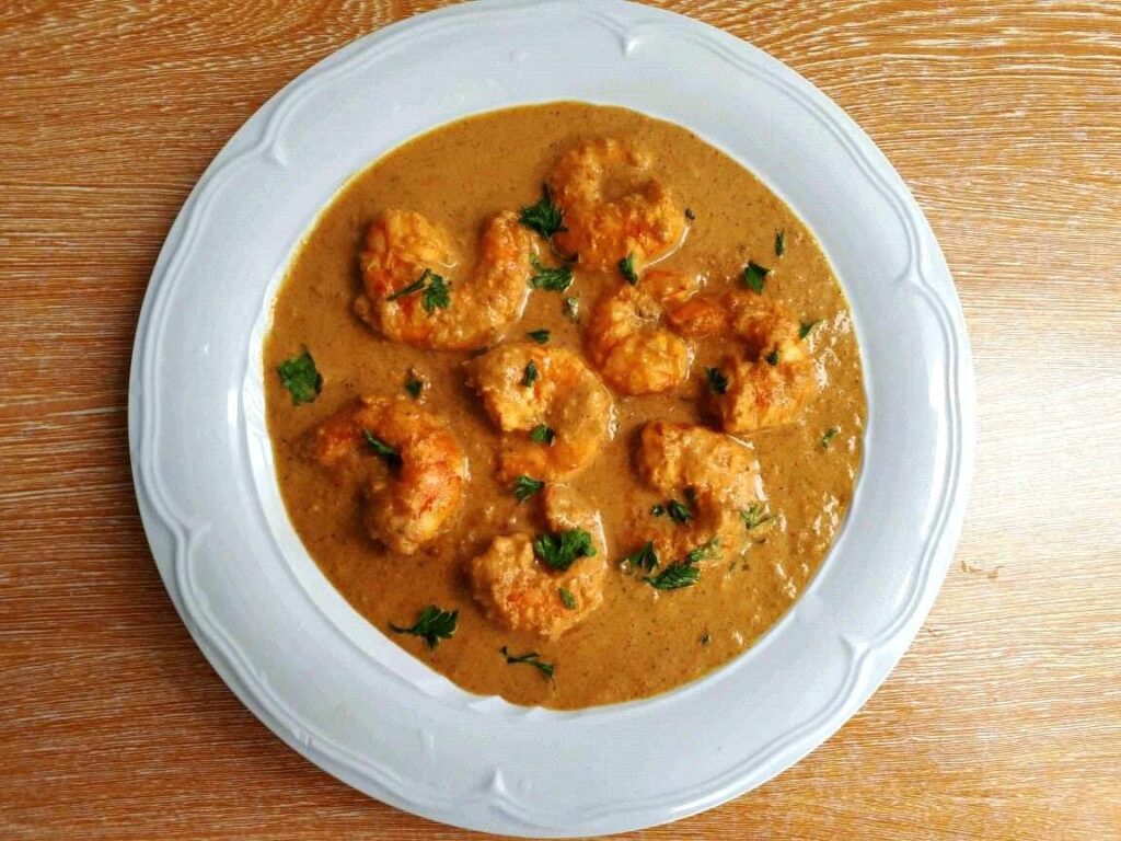 Creamy and Spicy Prawn Masala Recipe garnish with chopped coriander in a plate.