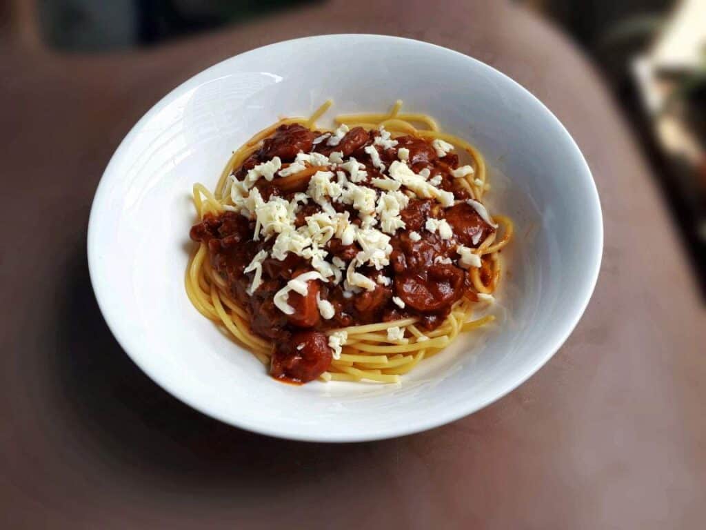 Filipino Style Spaghetti with Red sauce and topping of grated cheese