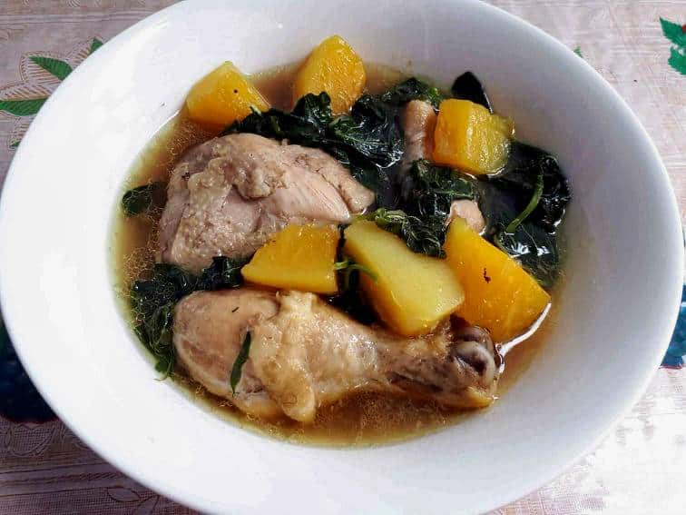 Chicken Papaya Recipe mixed with unriped papaya, chicken, spinach and with seasoned broth served on a plate bowl.