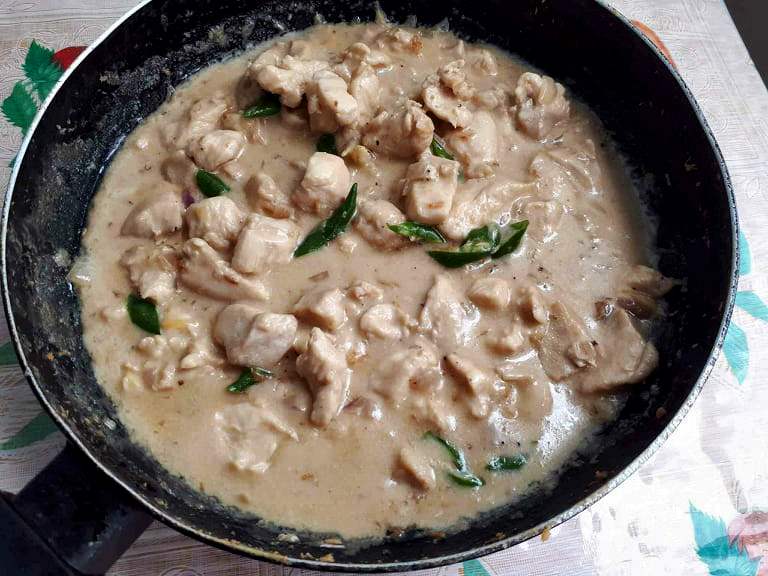 Chicken Bicol Express Recipe mixed with chopped chicken breast, chopped green chilies cooked in coconut milk served in a pan
