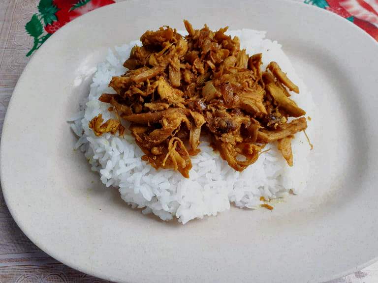 Chicken Pastil Recipe made with white steamed rice topped with dry shredded chicken serve in a plate.