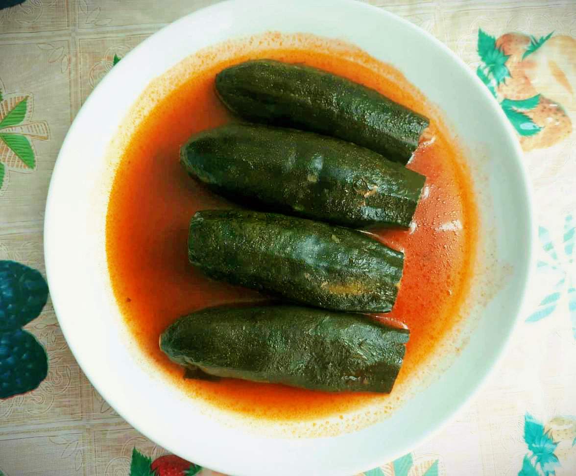 A Lebanese stuffed Zucchini called Kousa Mahshi served with tomato broth on a plate