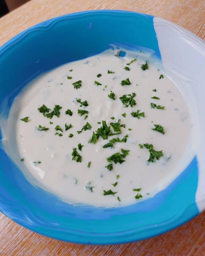 Yogurt Garlic sauce sprinkled with chopped parsley on a plate bowl best for Shawarma, Kebab or Salad dressing