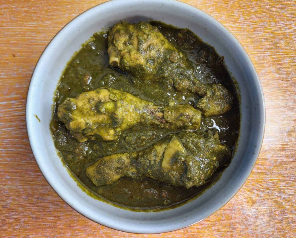 Indian Spinach Chicken Curry Palak Chicken drumstick serve on a plate