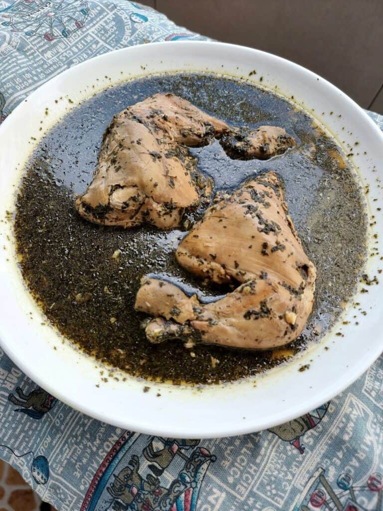 Chicken Molokhia: Middle Eastern green stew with chicken, molokhia leaves, garlic, herbs, and spices served on a plate