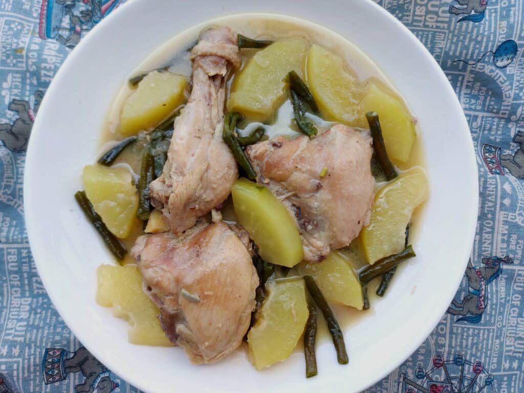 Filipino chicken coconut milk stew Ginataang Manok with Papaya and Green beans served on a plate