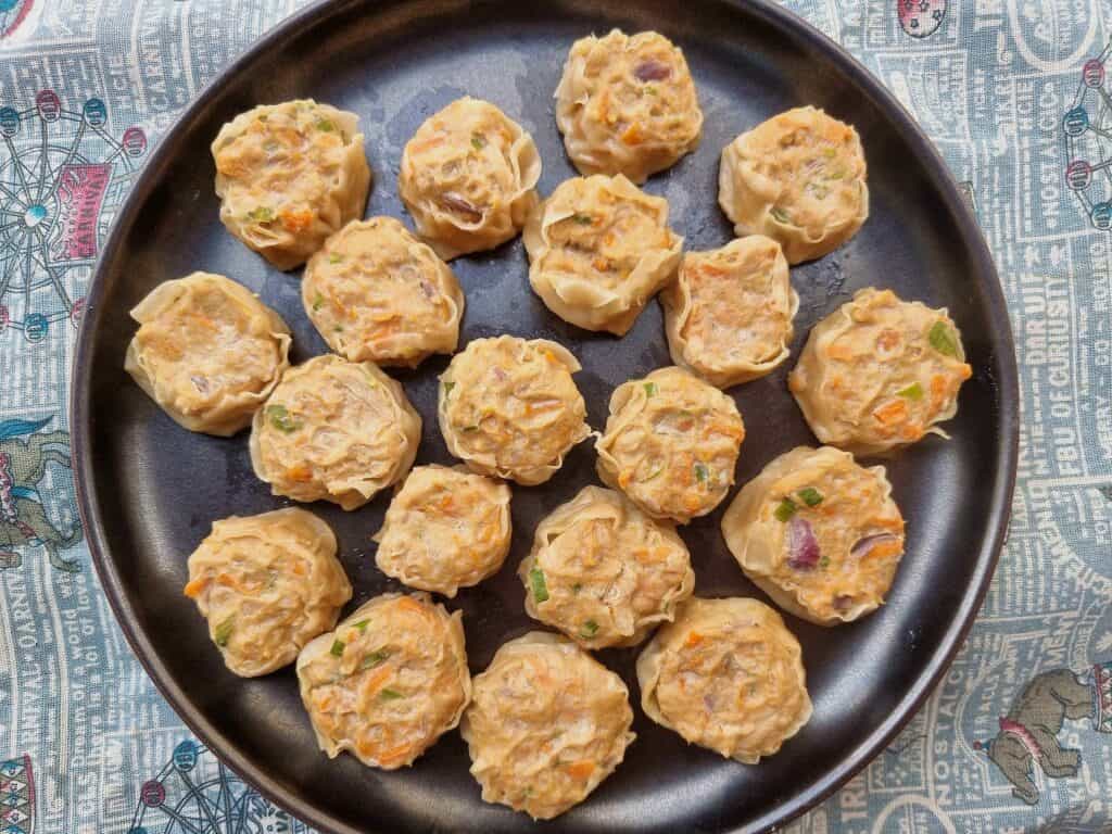 A close-up photo of delicious chicken siomai dumplings served on a plate. 